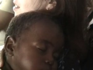 Lana Holding Sleeping Orphan in Swaziland